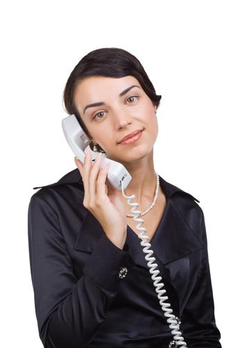 Business woman with a telephone receiver in hand