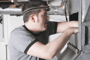 AC Technician cleaning vents and ducts