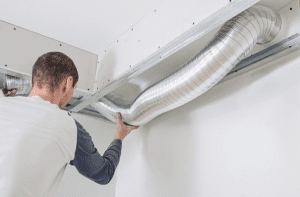 Technician holding ventilation system