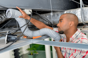 Technician installing HVAC parts 