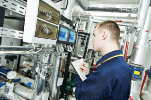 repairman inspecting HVAC system