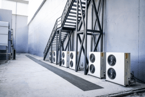 commercial ac units outside building underneath staircase 