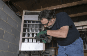 Technician inspecting gas furnace 