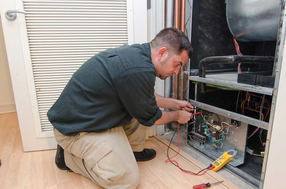 HVAC technician working on a residential heat pump